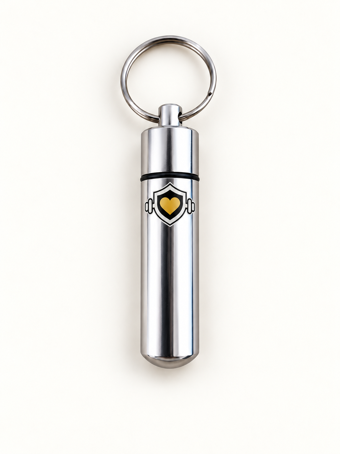 Silver 2ND TREK keychain capsule with gold heart and barbell emblem